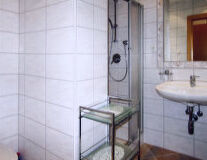 a glass shower door and a sink